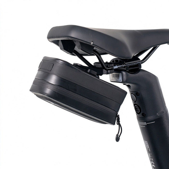 The black ADO CB11 bicycle saddle bag securely mounted under the bike seat using the AQS Mag quick-release system, offering compact storage for your ride.